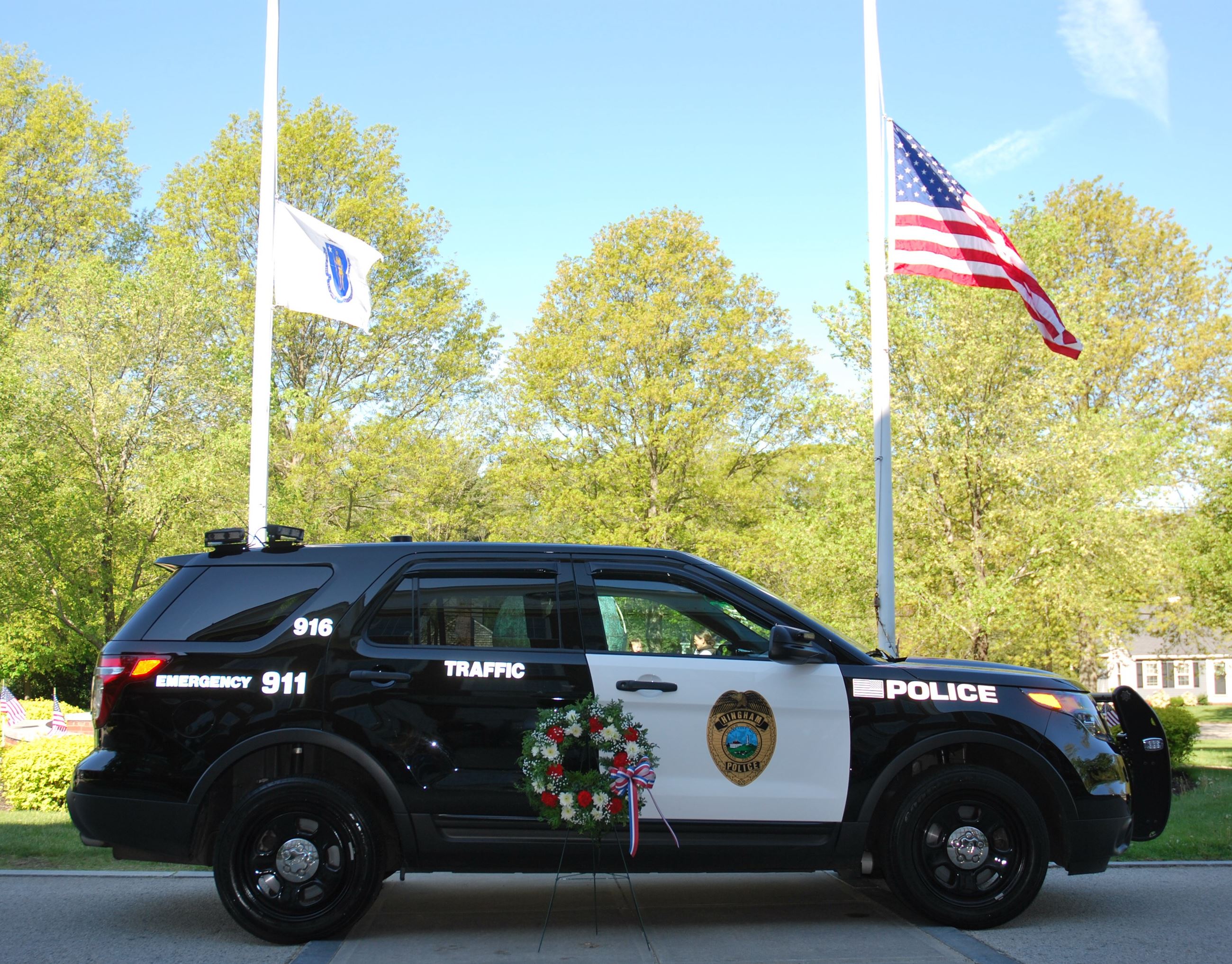 Hingham Police vehicle and Veterans Memorial, flag
